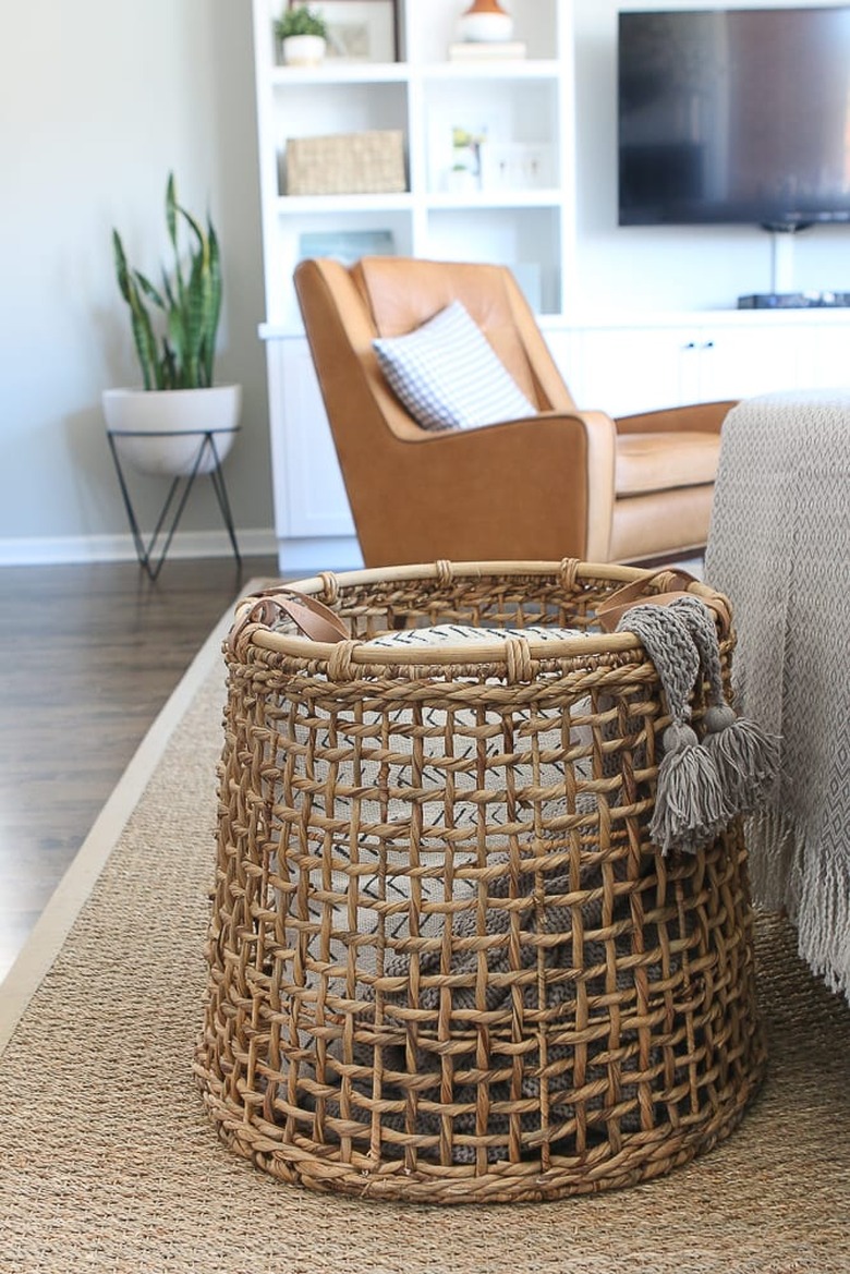 Living room storage ideas with woven basket for blankets