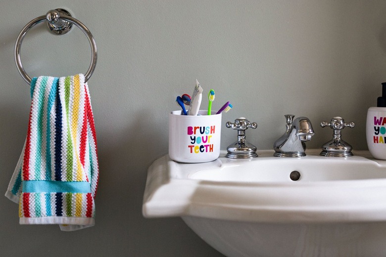 bathroom sink with rainbow colored hand towel in kid's bathroom