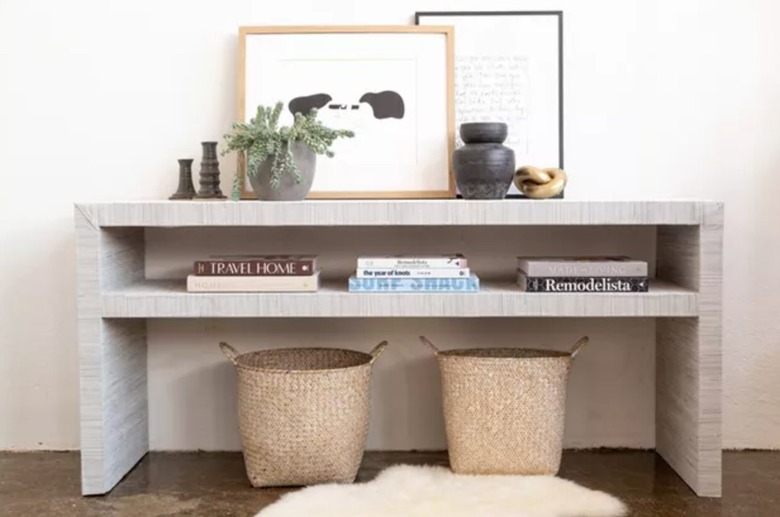 Console table covered in grasscloth.