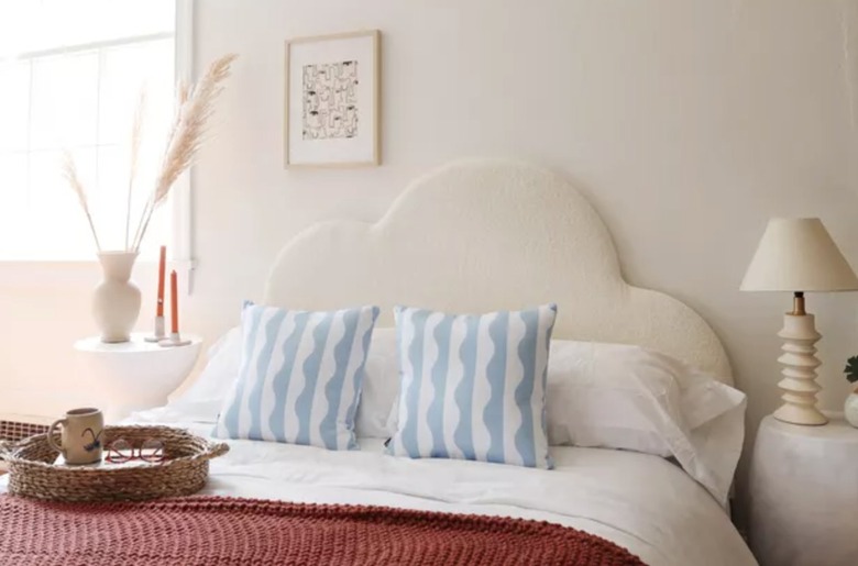 Bedroom with cloud shaped headboard, pillows.