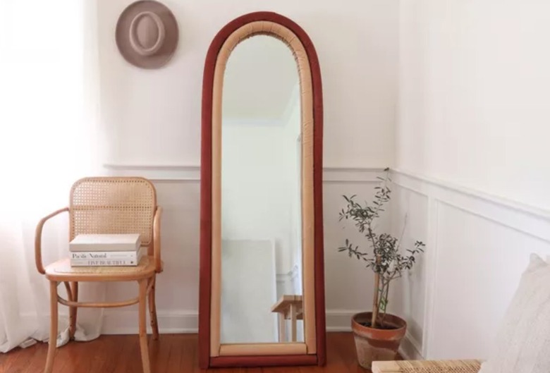 Floor length mirror, chair, books.