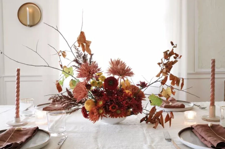 Autumn centerpiece, candles, dishes.