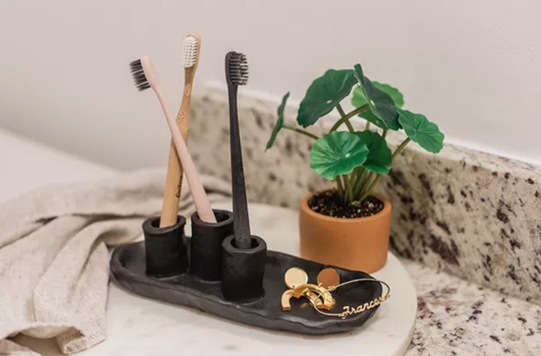 Black clay toothbrush holder.