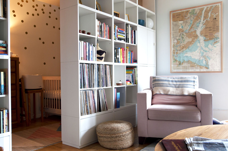 chair near bookshelves with nursery in the background