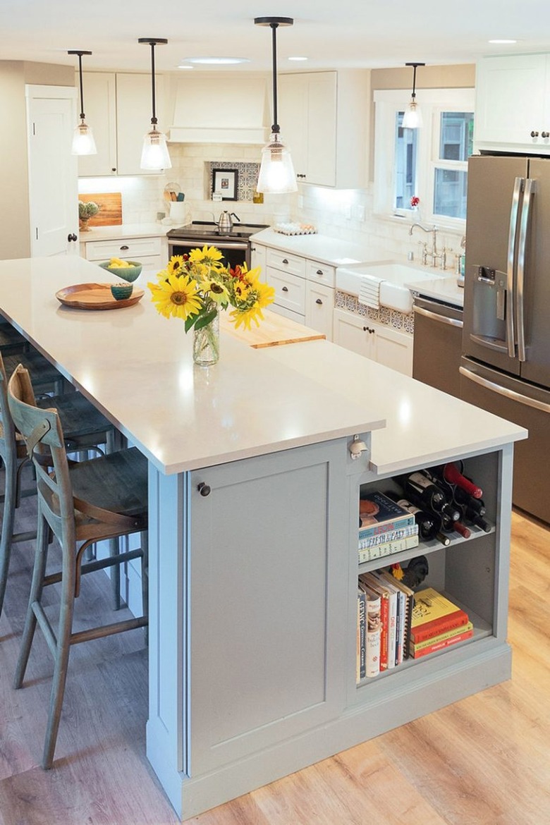 blue two-tier kitchen island with kitchen cabinet and shelving