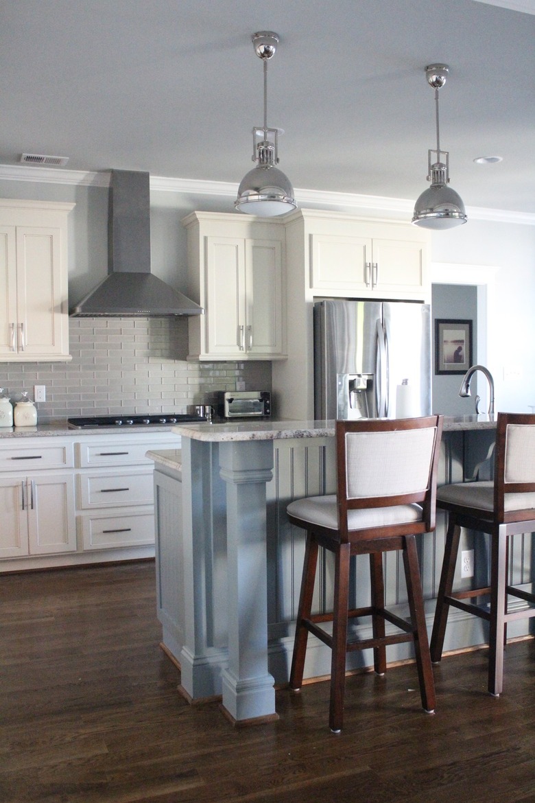 two-tier kitchen island with beadboard in white kitchen