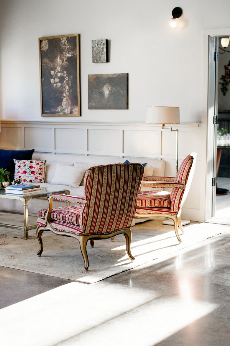 Formal sitting area with red and gold striped fabric chairs