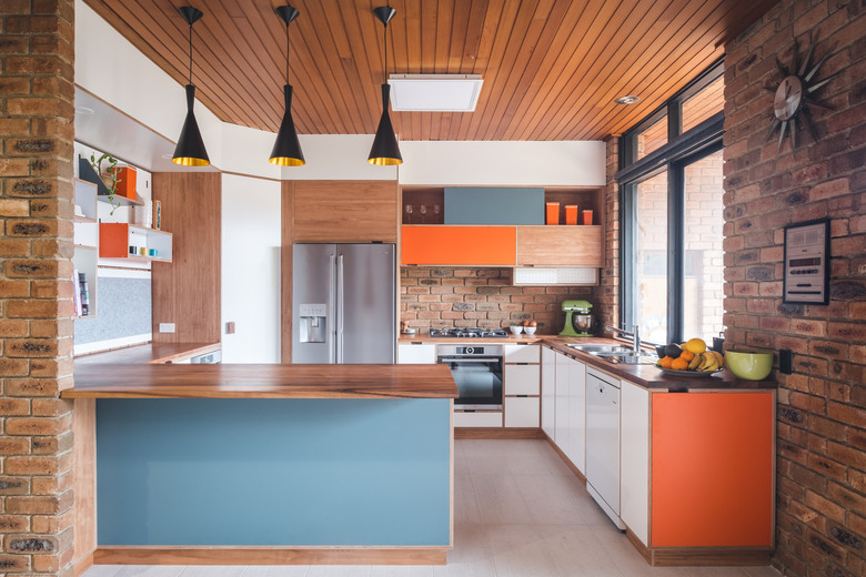 two-tone kitchen color idea with orange and blue midcentury kitchen