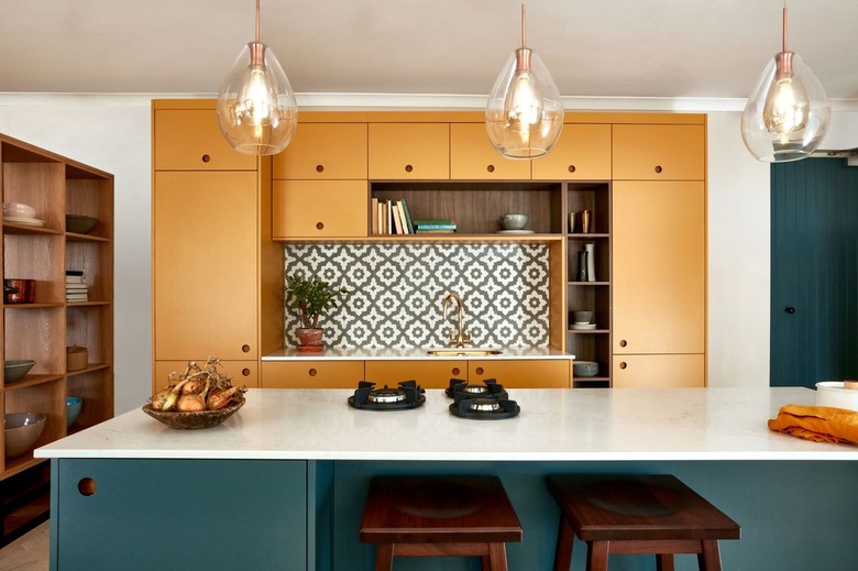 two-tone kitchen color idea with mustard yellow and teal kitchen cabinetry