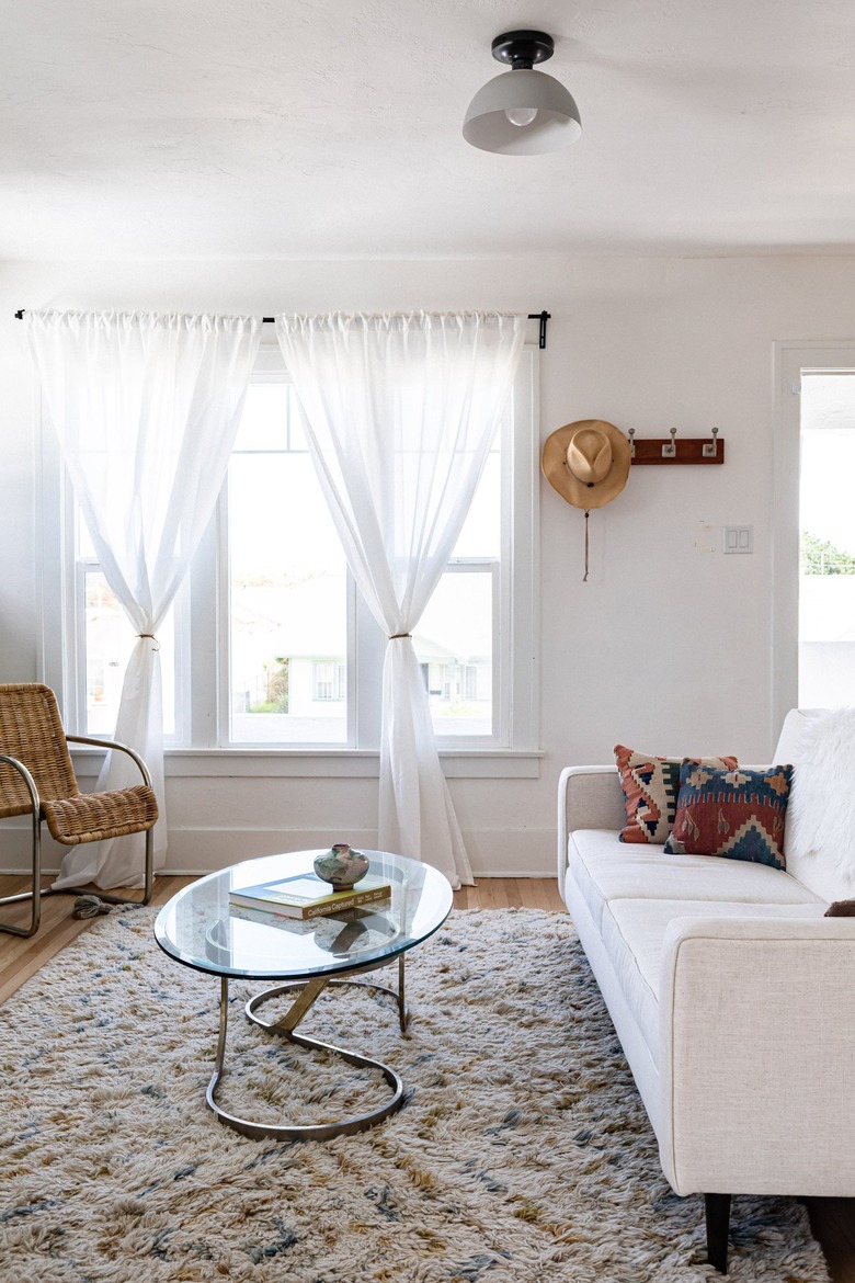 living room with sheer curtains in front of windows