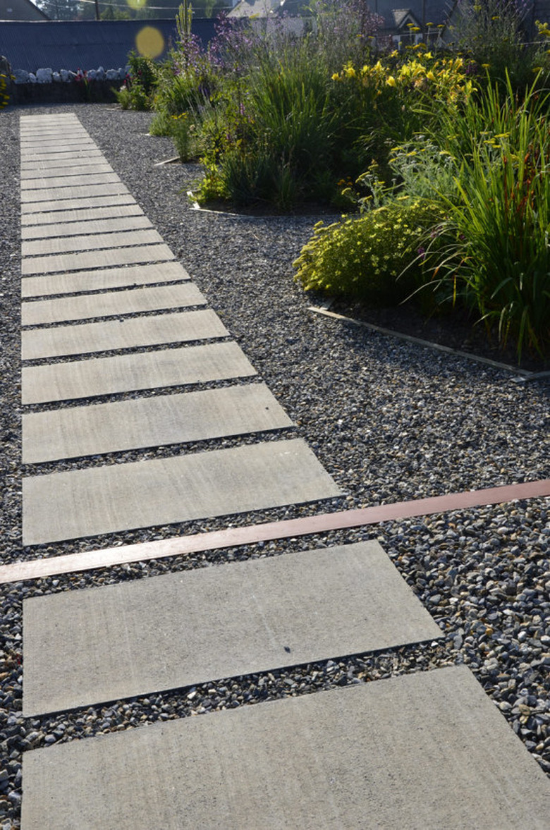 world landscape architecture multiple hardscape materials stone tile walkway surrounded by gravel