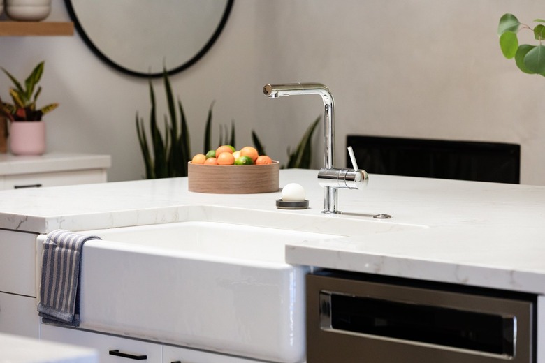 marble kitchen countertop with apron sink and chrome faucet