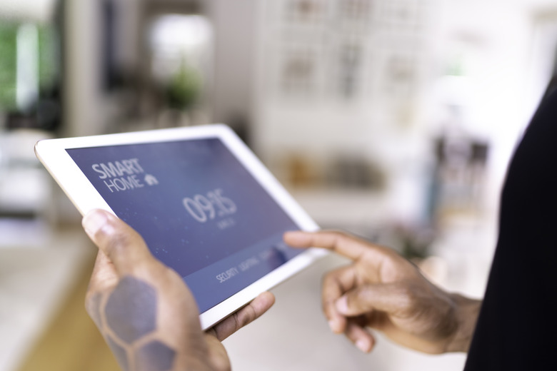 Man using digital tablet for control the home automation at home