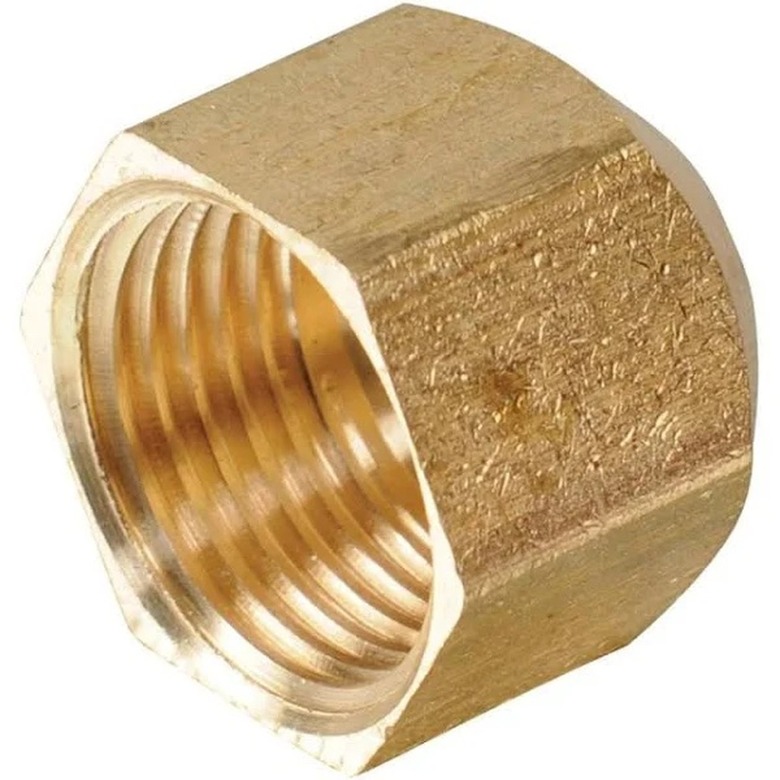 A brass plumbing cap