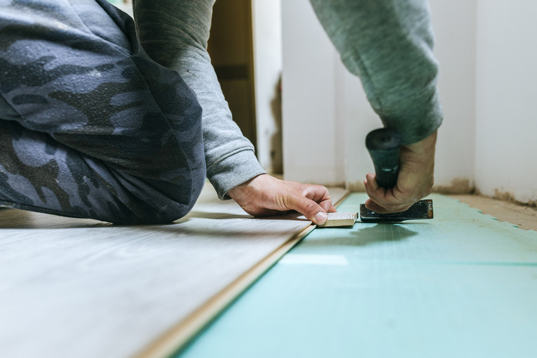 Close-up of man placing parquet floor