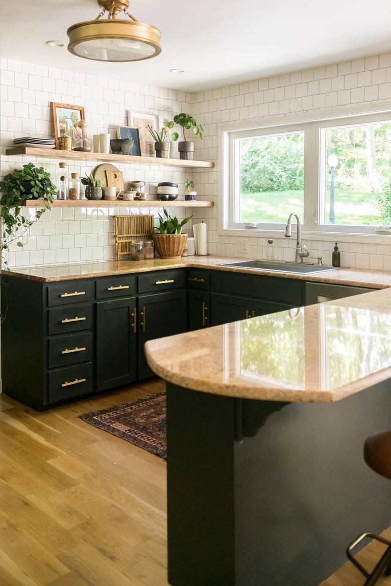 black and wood u-shaped kitchen with white tile backsplash