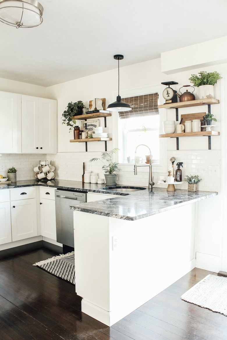 white u-shaped kitchen with gray granite countertop