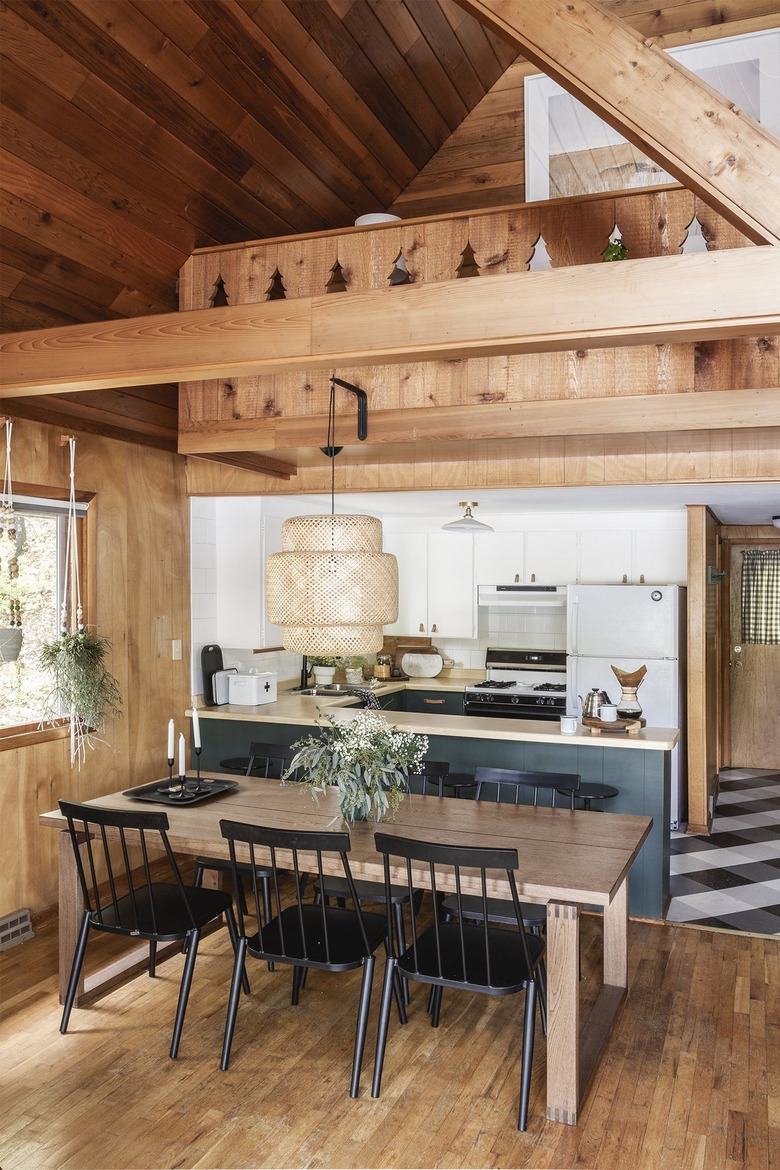 modern u-shaped kitchen next to dining area in cabin