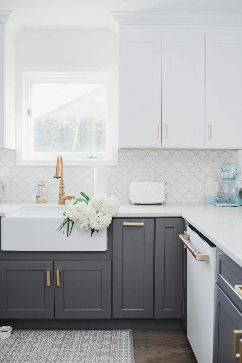 white and gray u-shaped kitchen with fish tile backsplash