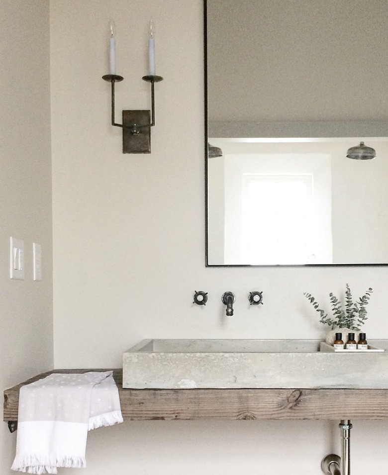 concrete bathroom sink in contemporary bathroom with wood countertop