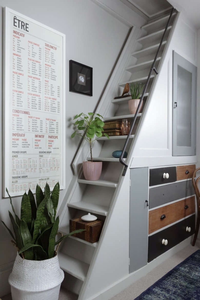 Under the stairs storage with mismatched vintage drawers and decor