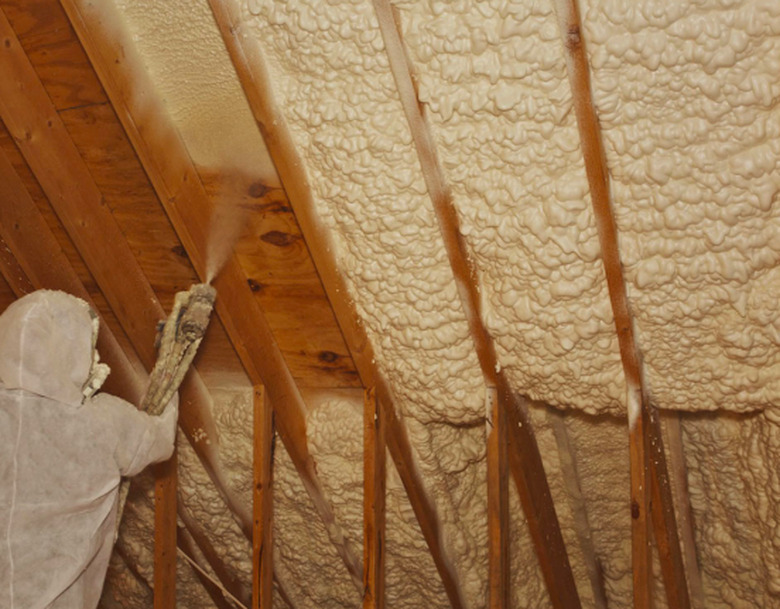 Installing spray foam insulation.