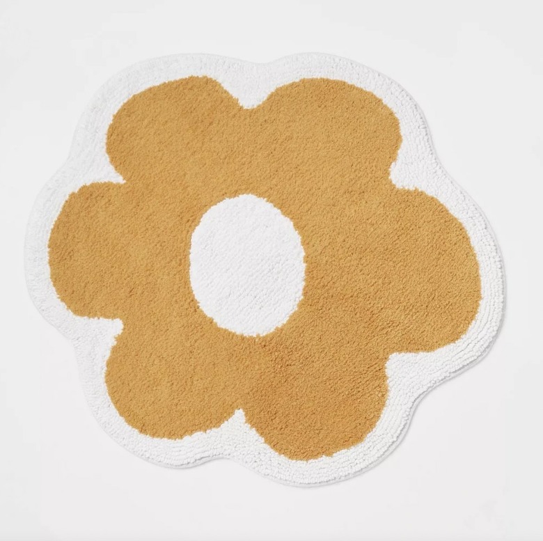 orange and white flower bath mat