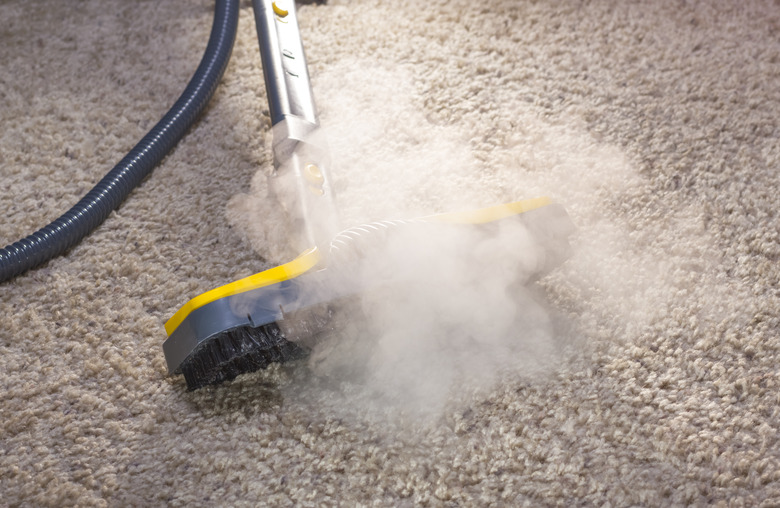 Steam cleaning a carpet.