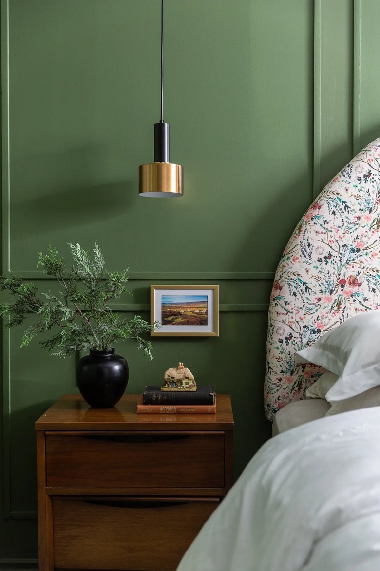 stack of books on nightstand in vintage bedroom