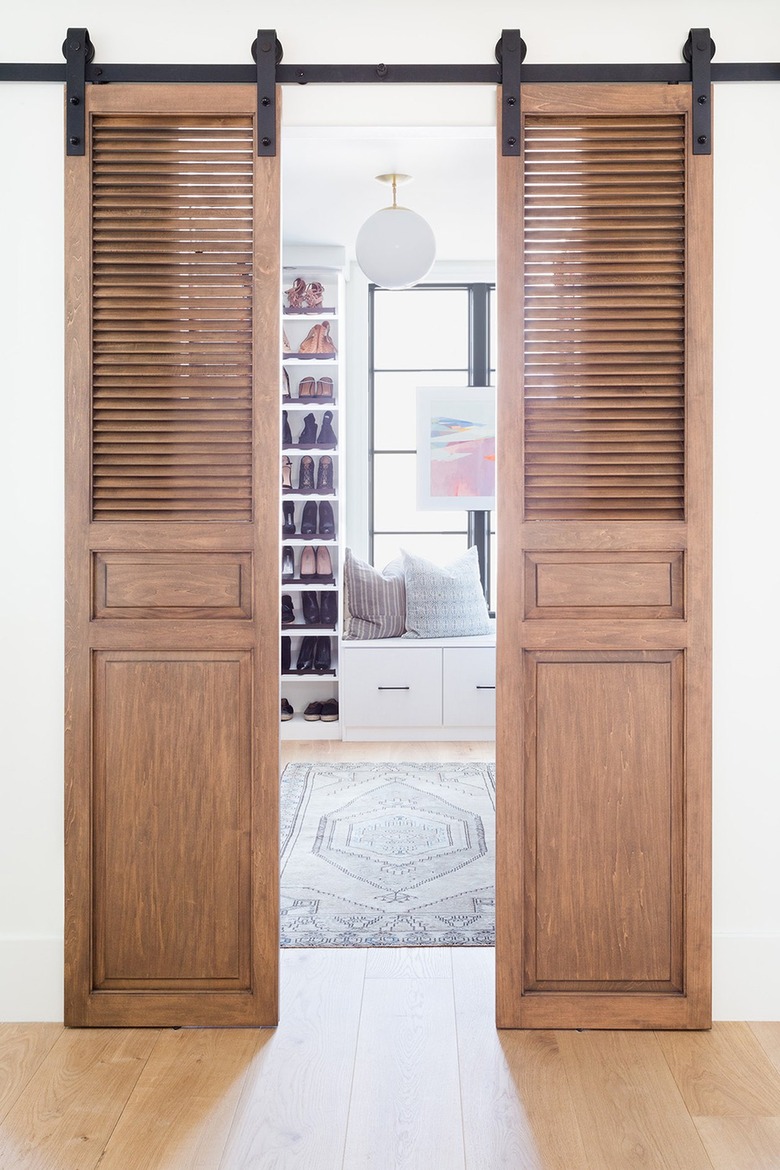 Two dark wood barn doors slightly ajar.