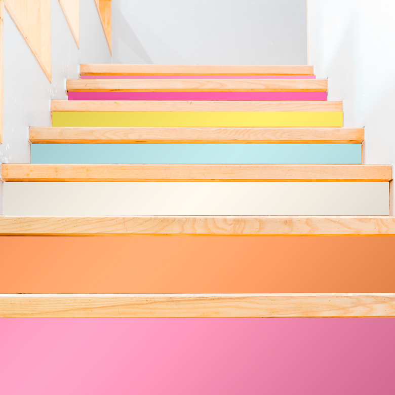 colorful stairs wallpaper on white staircase with wood treads