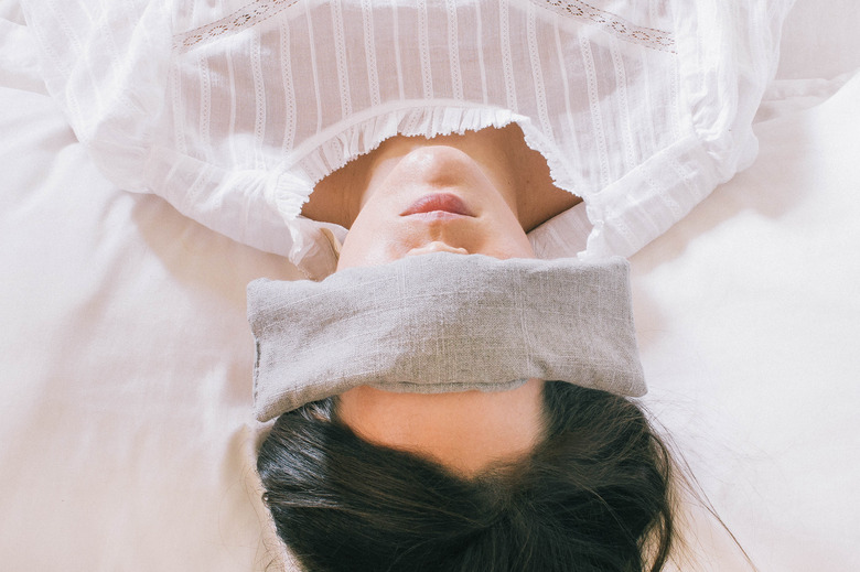 woman sleeping with eye pillow