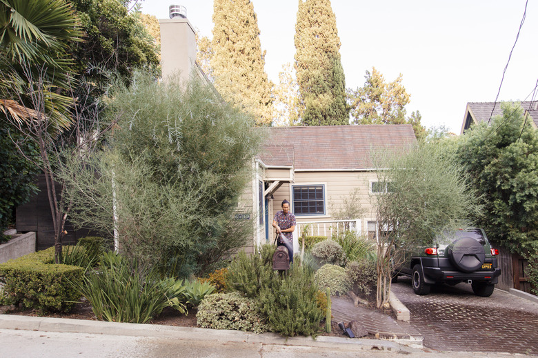 Man watering front yard