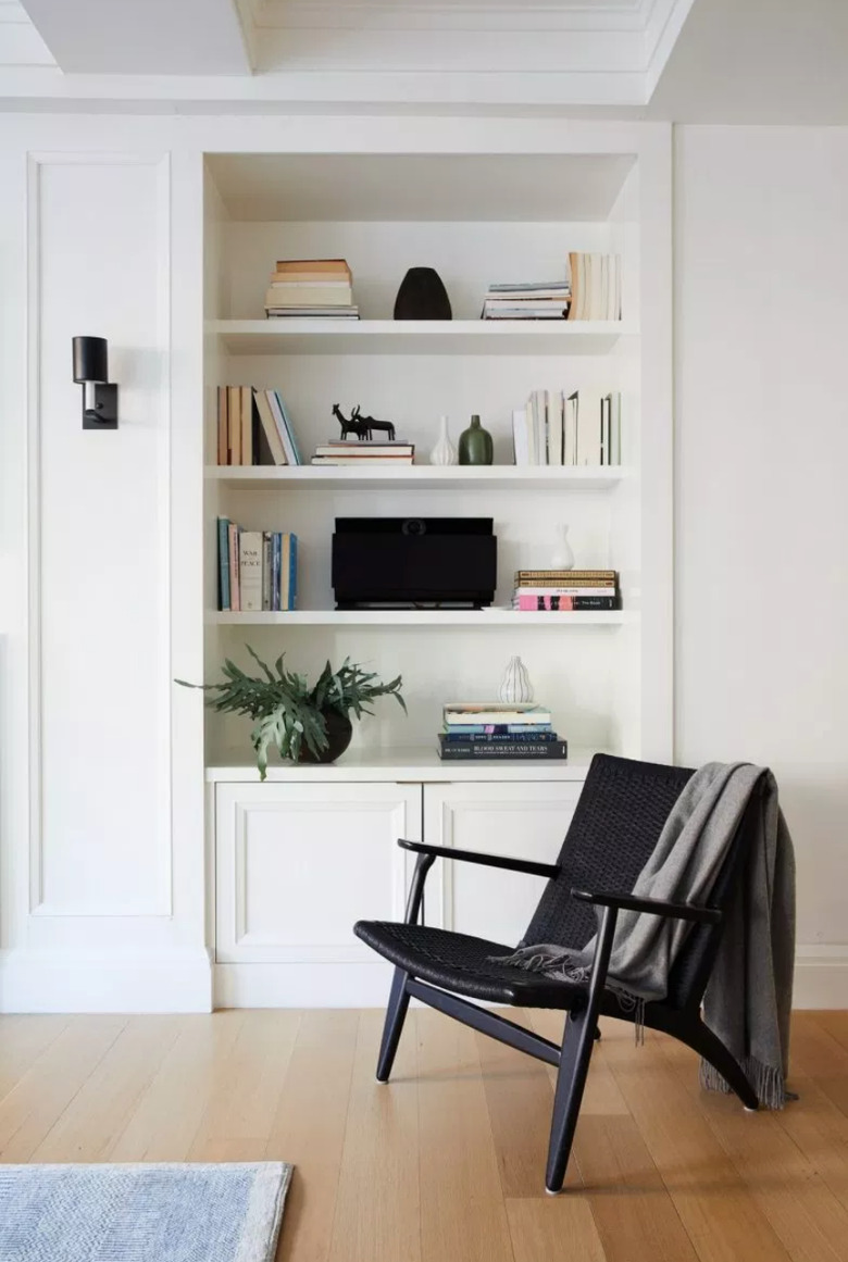 black-and-white living room idea with black accent chair and built-in bookcase