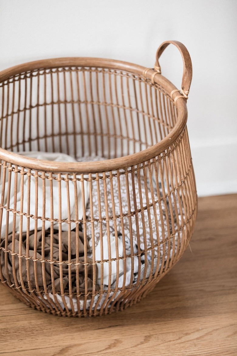 large wooden basket filled with laundry