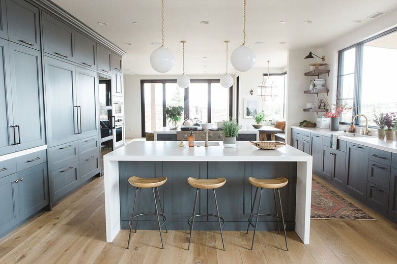 White waterfall countertop in blue kitchen by Studio McGee