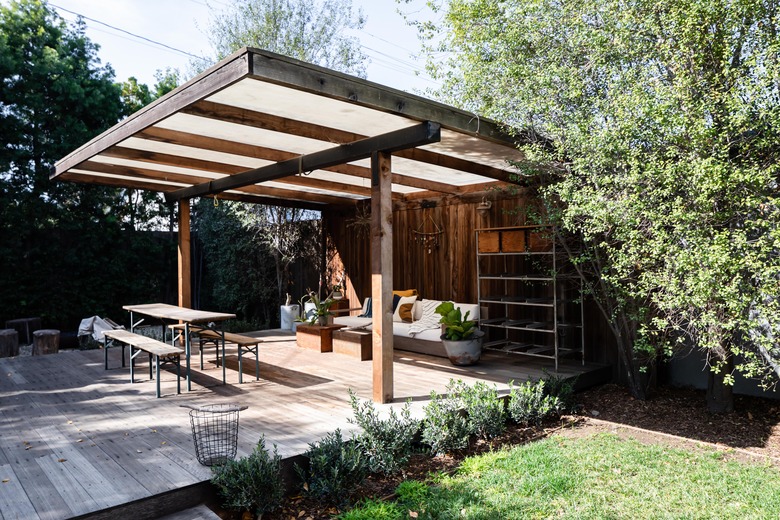 Pergola in backyard over outdoor seating area