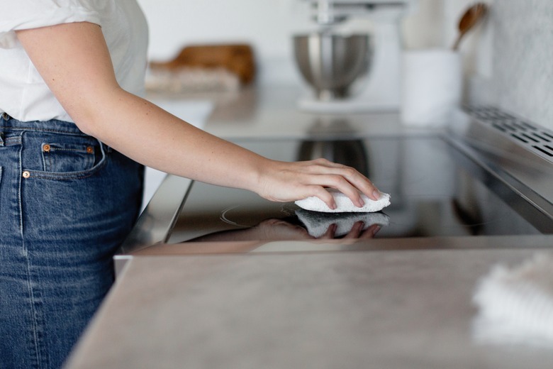 Woman cleaning stovetop