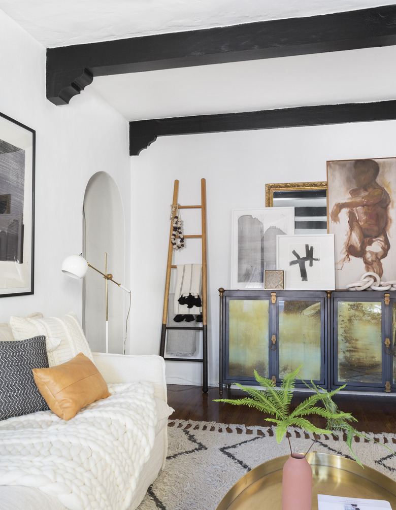 living room with black exposed ceiling beams