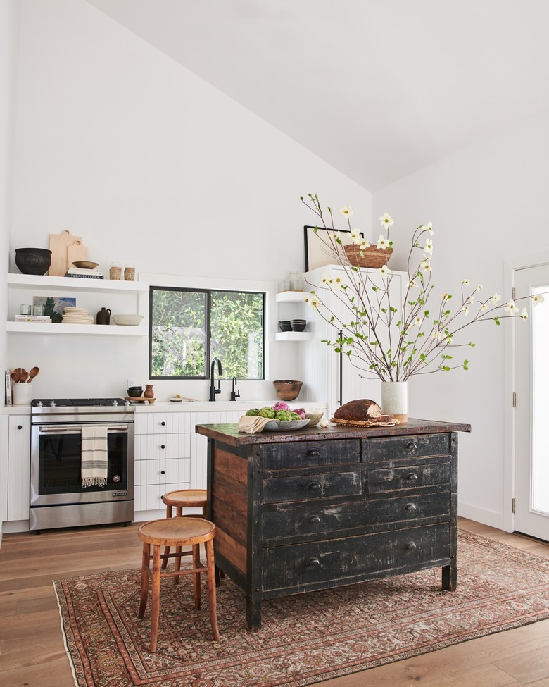 white kitchen with distressed freestanding island