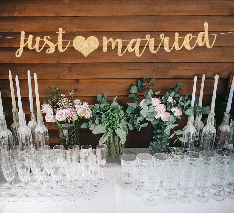 just married banner above glassware, candles, flowers