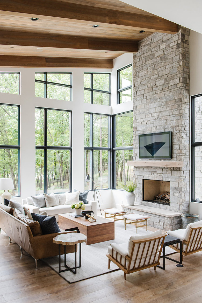 rustic living room idea with wood beams and stone fireplace