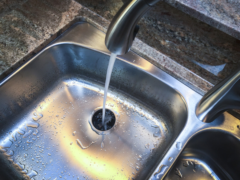 A kitchen sink with running water