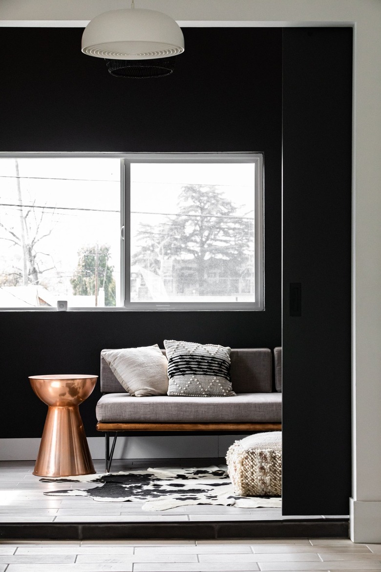 Bold black and white walled living room with gray-brown accents