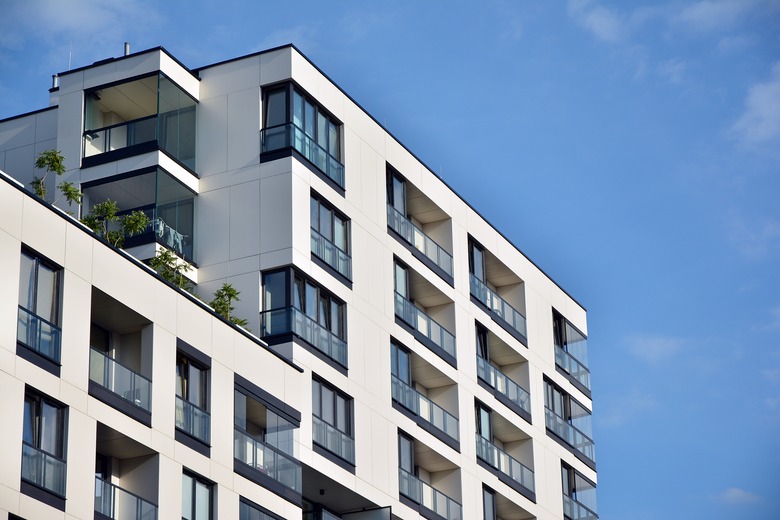 Modern apartment buildings on a sunny day with a blue sky.