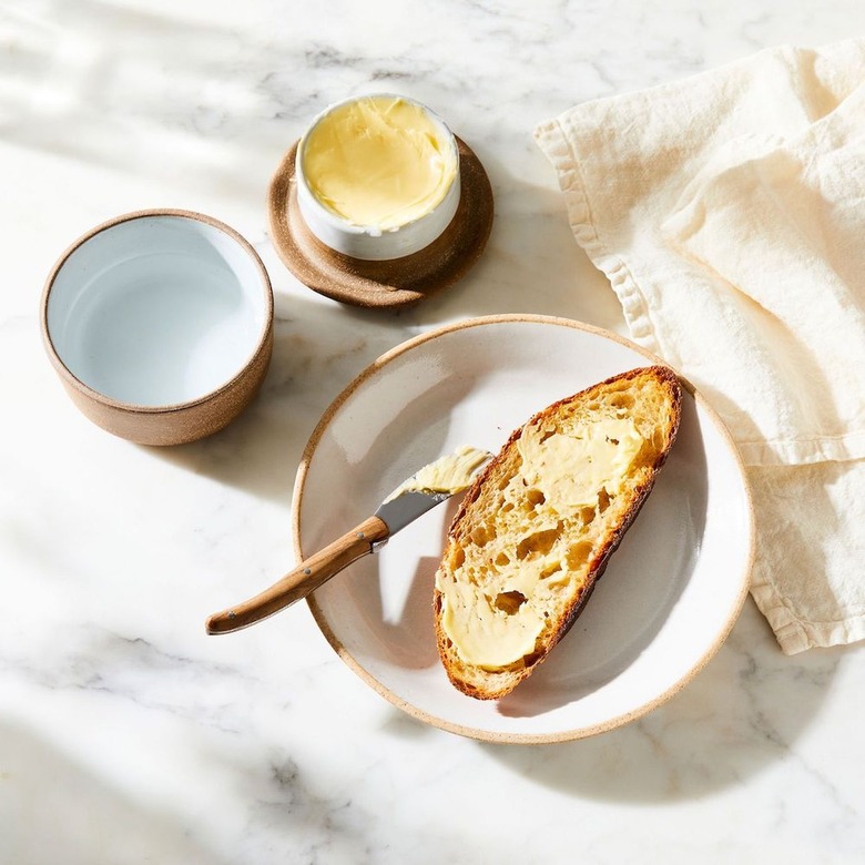 ceramic butter bell with toast on plate