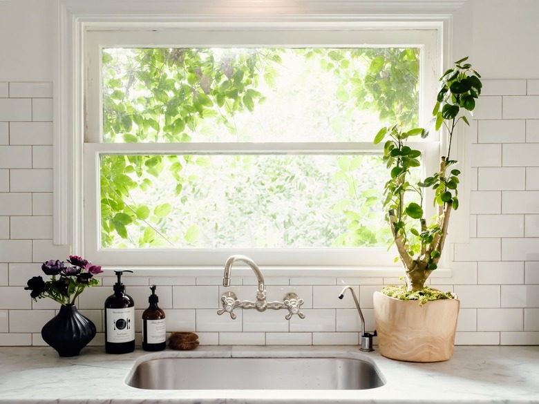 wall mounted faucet with undermount sink and white subway tile backsplash