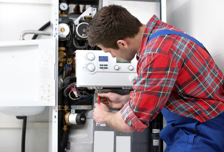 Technician servicing heating boiler