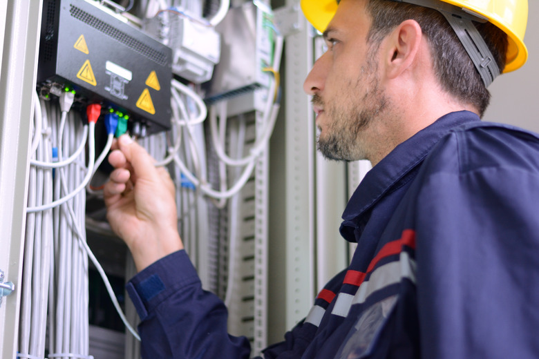 Electrician connecting cable to the switch.