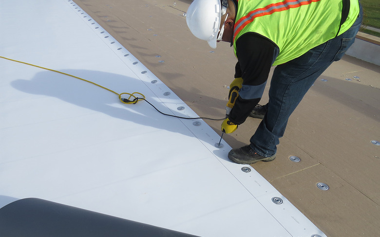 Installer securing TPO roofing.